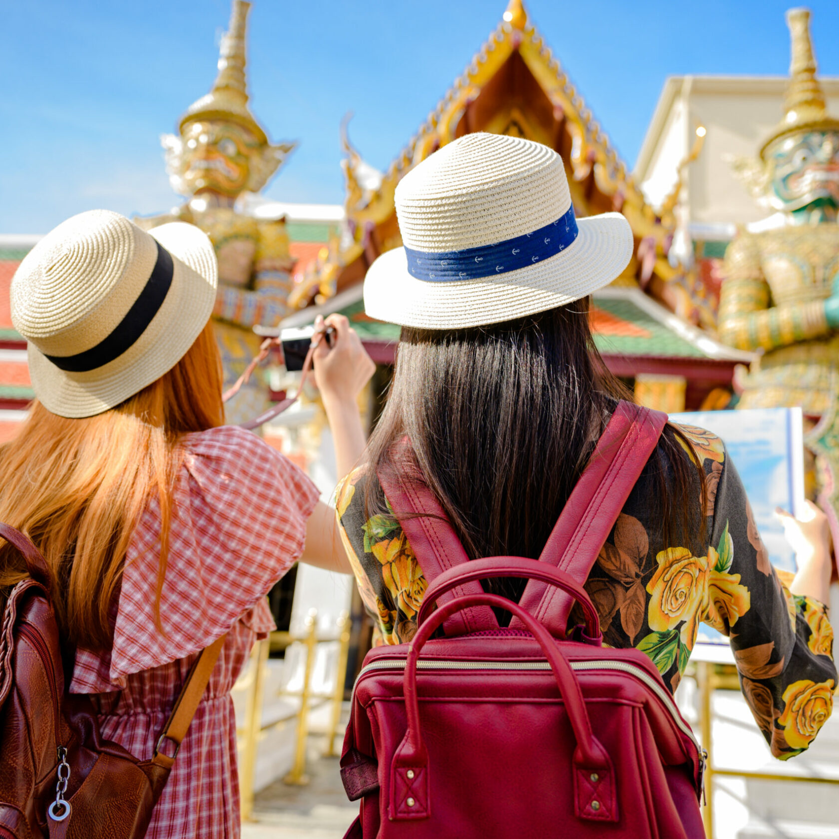 Charming young tourist women enjoy trip taking picture on the palace temple in Bangkok of Thailand, Emerald Buddha Temple, Wat Phra Kaew, Bangkok Royal Palace popular tourist place